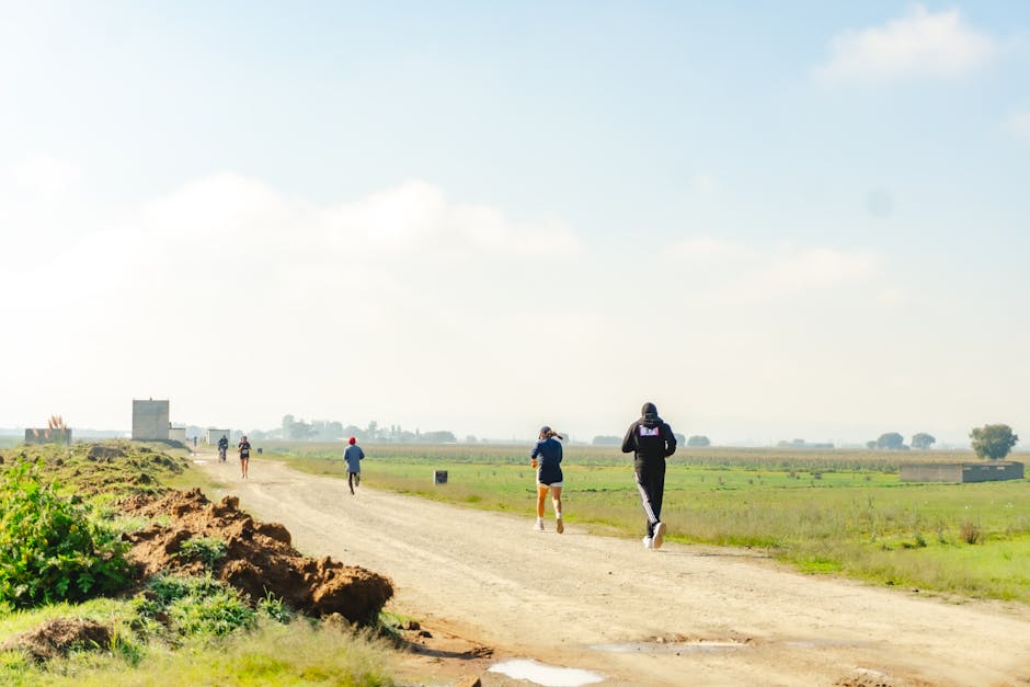Joggers running along a dirt road in rural Santa María Atarasquillo, México.