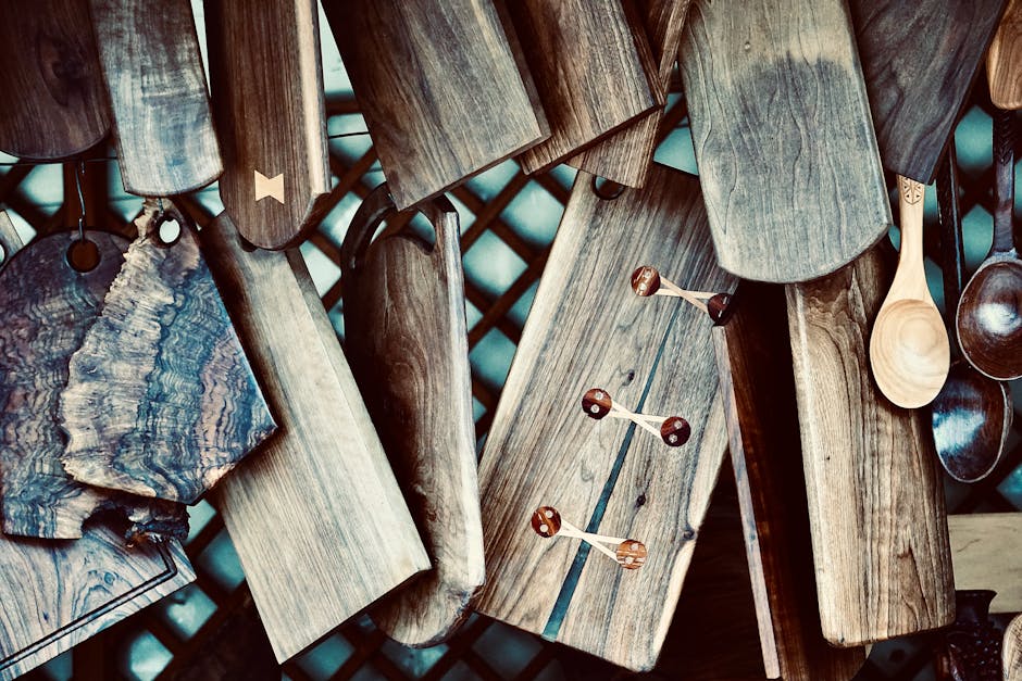 Hanging array of handmade wooden cutting boards and spoons with rustic feel.