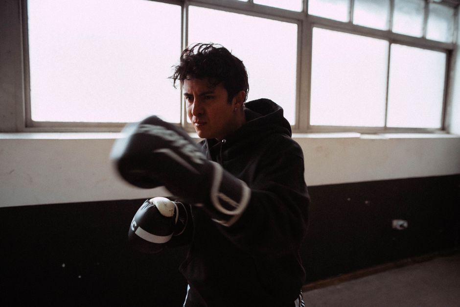 A dedicated boxer practicing in an indoor gym in Buenos Aires, showcasing determination and strength.