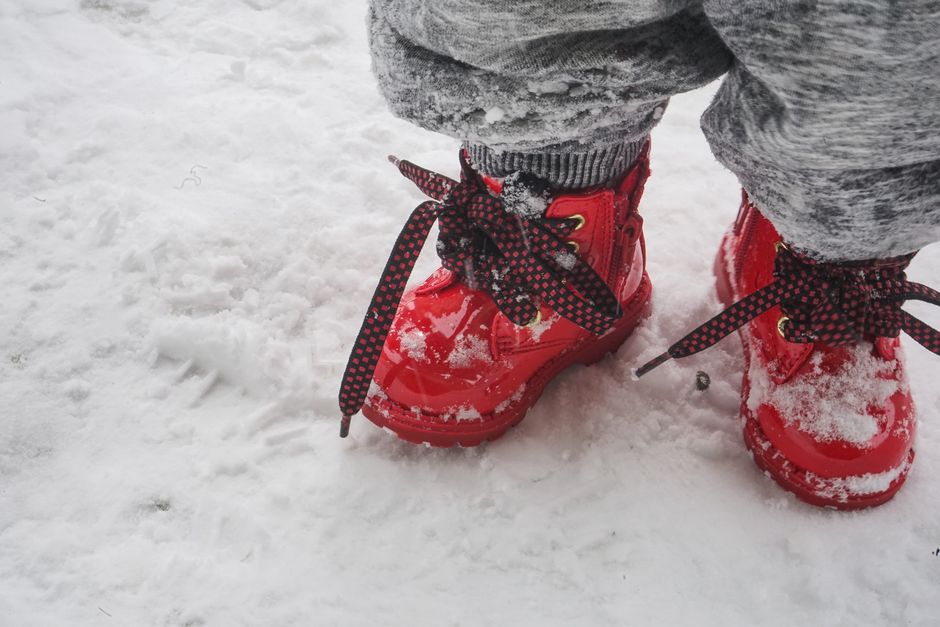 Bright red boots stand out against the snowy landscape in Zermatt, Switzerland.