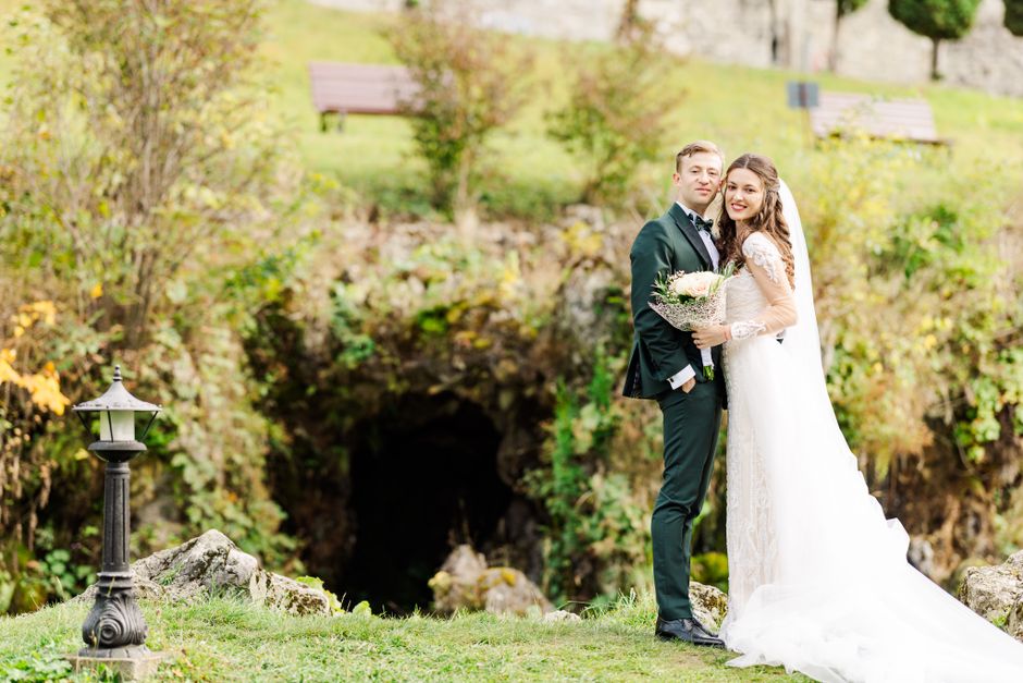 Bride and groom in an enchanting outdoor wedding setting in Bușteni, Romania.