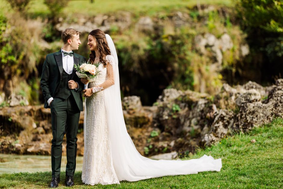 A couple poses in elegant attire for their outdoor wedding in Bușteni, Romania.